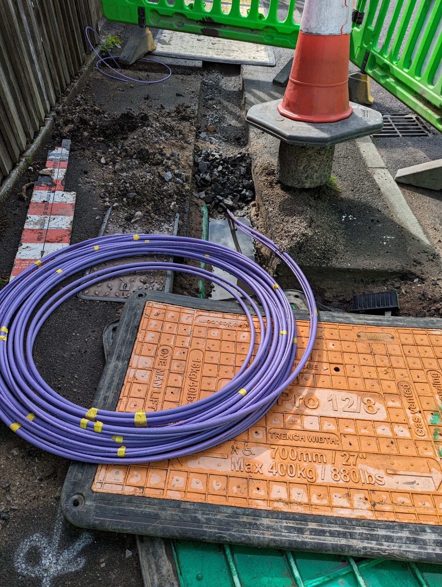 licensed-image (1) Fibre optic cable coming out of a trench curled up waiting to be installed for the UK gigabit broadband rollout being installed by the internet service providers ISPs across the country.